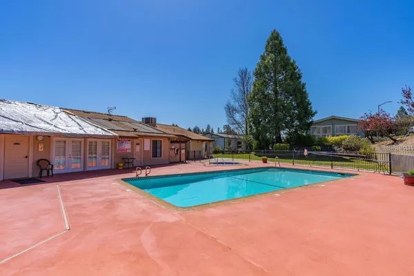 an aerial view of a house with yard swimming pool and outdoor seating