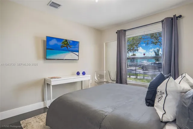 a bedroom with a bed and a desk