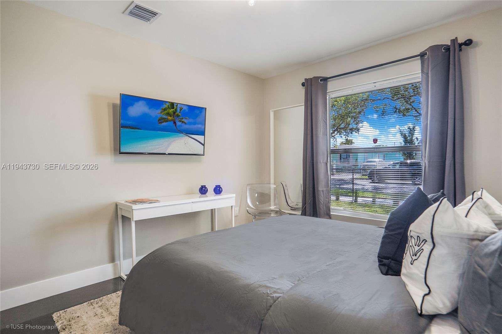 1035 Northwest 48th Street Miami, FL 33127 - Photo 11 of 29 a bedroom with a bed and a desk