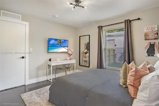 a living room with furniture a rug and white walls