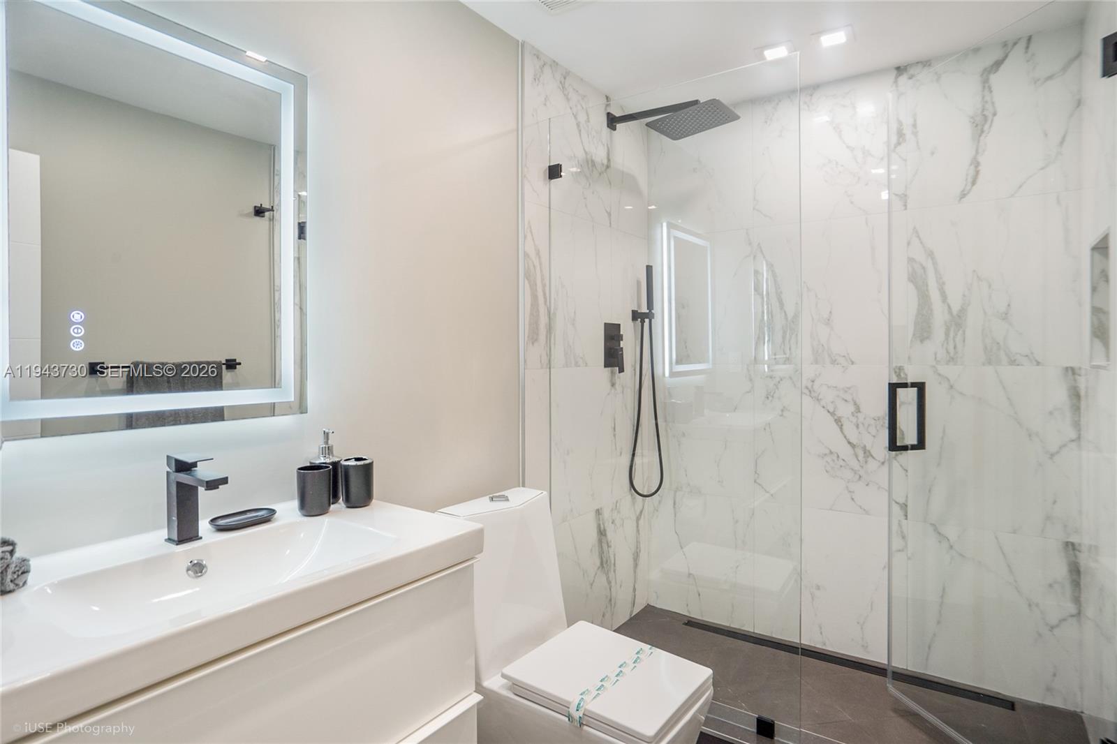 1035 Northwest 48th Street Miami, FL 33127 - Photo 13 of 29 a bathroom with a sink a toilet and shower