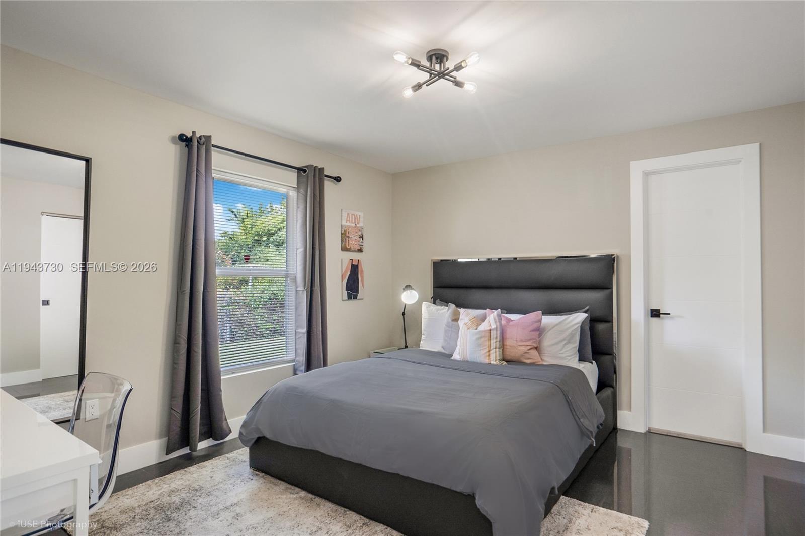 1035 Northwest 48th Street Miami, FL 33127 - Photo 14 of 29 a bedroom with a bed and a window