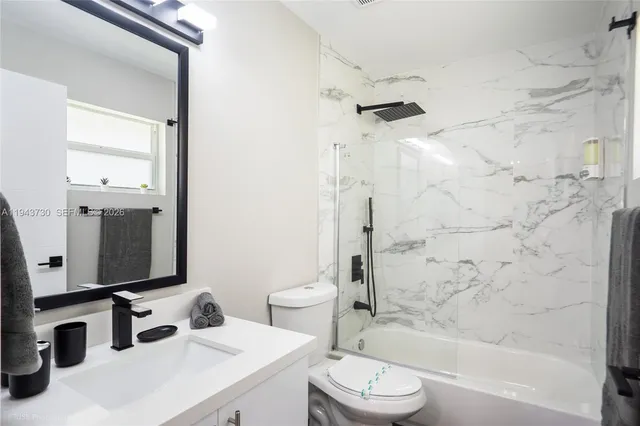 a bathroom with a sink toilet tub and shower