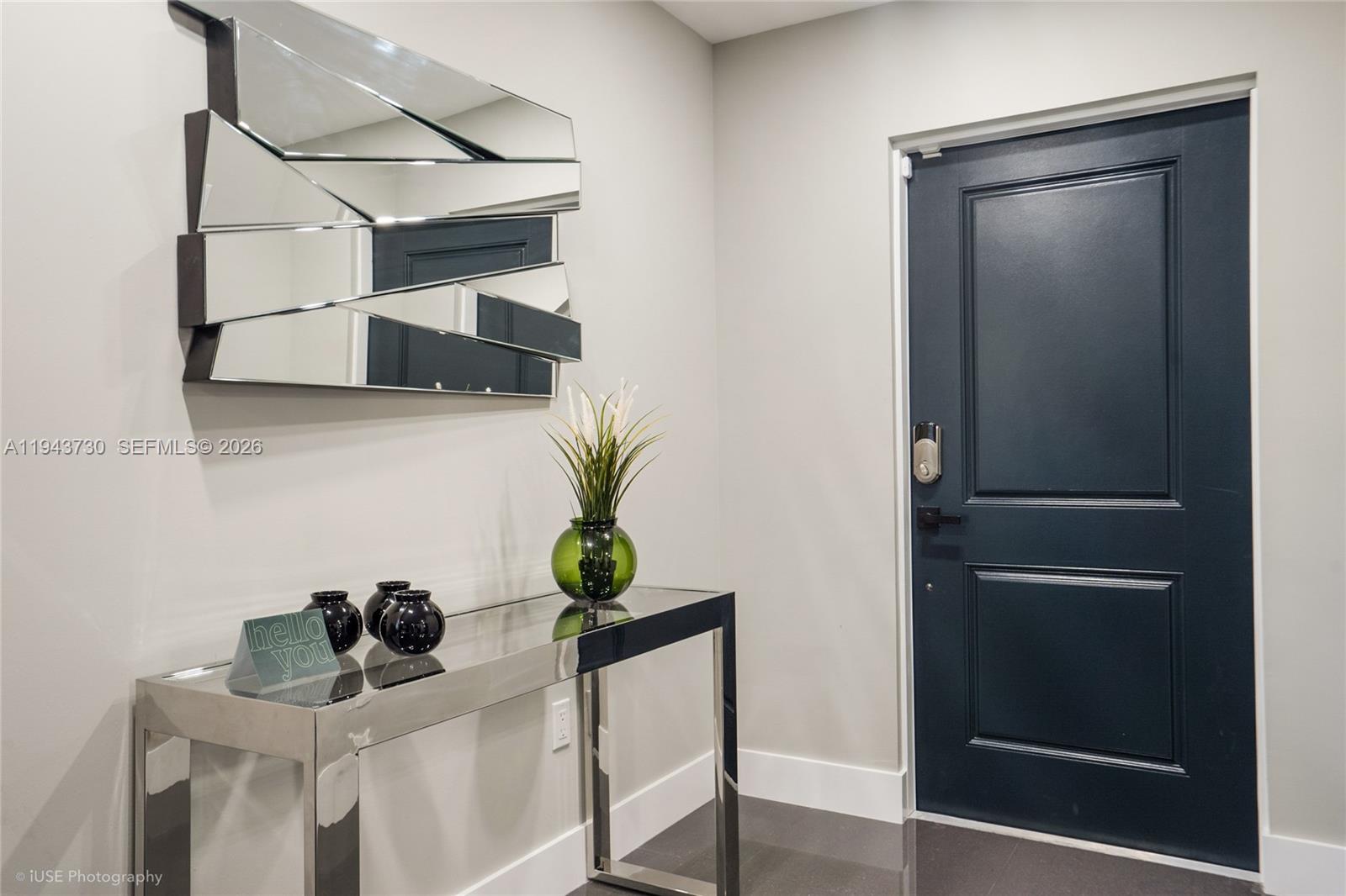 1035 Northwest 48th Street Miami, FL 33127 - Photo 19 of 29 a room with a potted plant on a table and a mirror