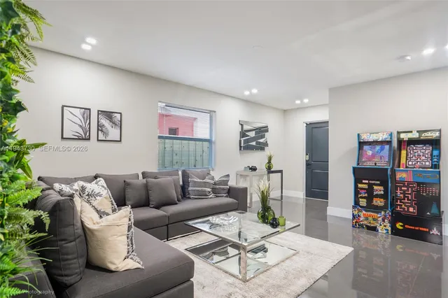 a living room with furniture and a painting