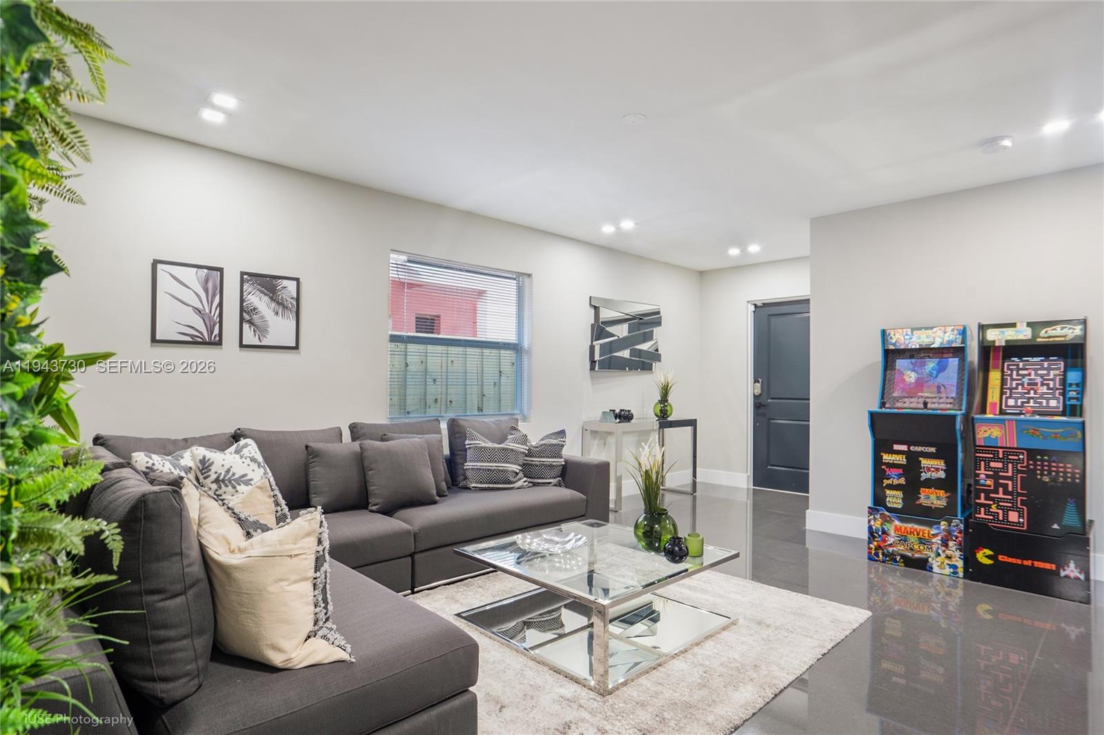 1035 Northwest 48th Street Miami, FL 33127 - Photo 20 of 29 a living room with furniture and a book shelf