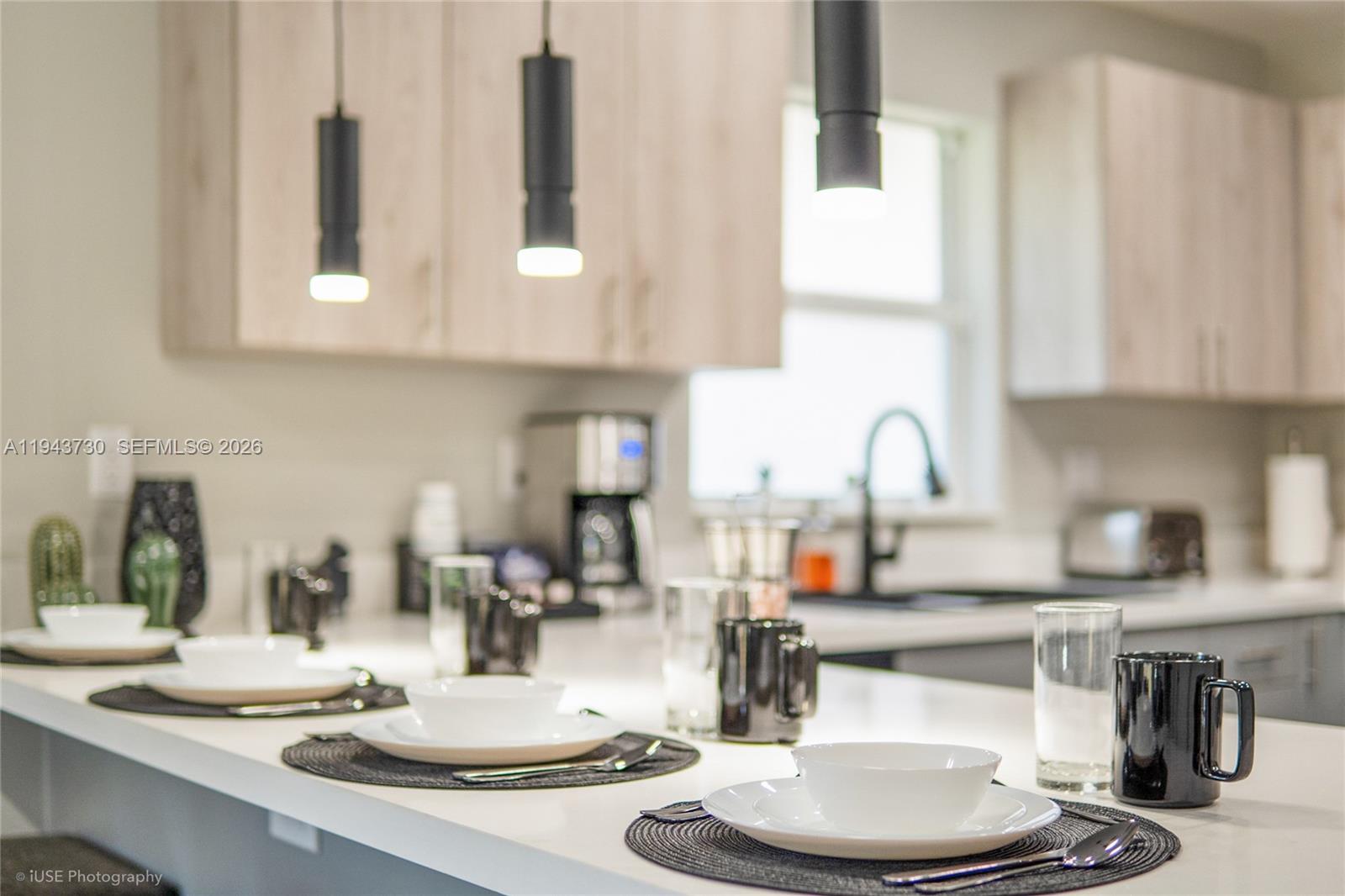 1035 Northwest 48th Street Miami, FL 33127 - Photo 25 of 29 a kitchen with kitchen island granite countertop a white table and chairs