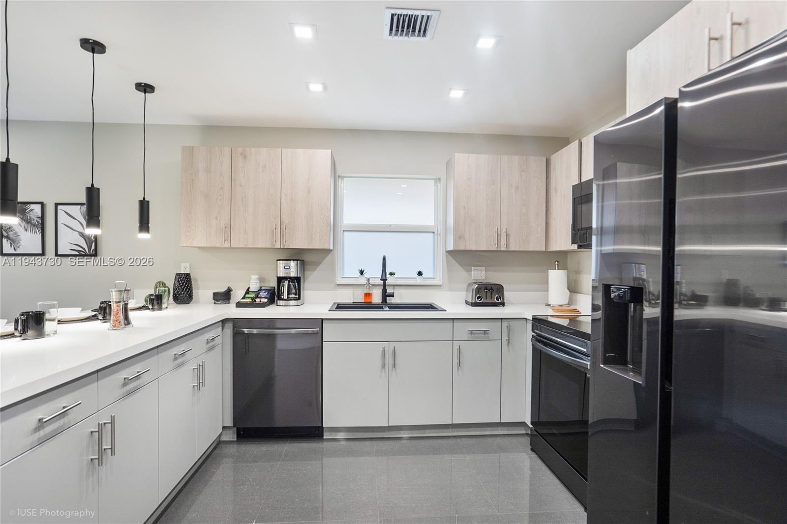 1035 Northwest 48th Street Miami, FL 33127 - Photo 3 of 29 a kitchen with a sink window and cabinets