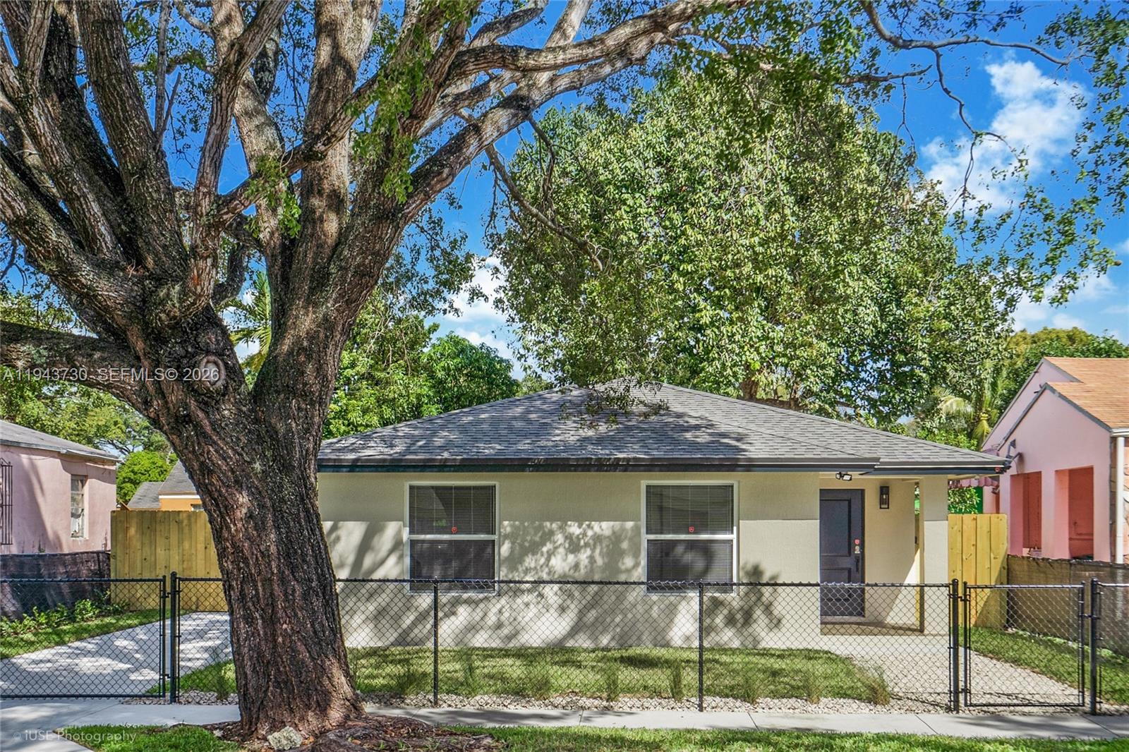 1035 Northwest 48th Street Miami, FL 33127 - Photo 4 of 29 a front view of a house with garden