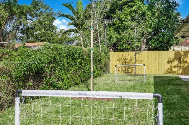 a wooden fence with trees in the background