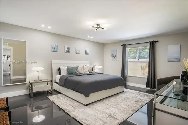 a bedroom with a large bed and a window