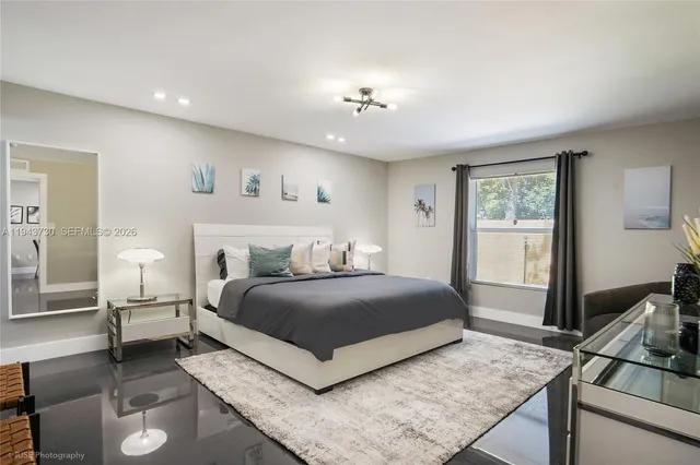 a bedroom with a large bed and a window