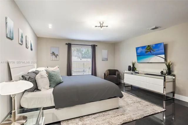 a bedroom with a bed and wooden floor