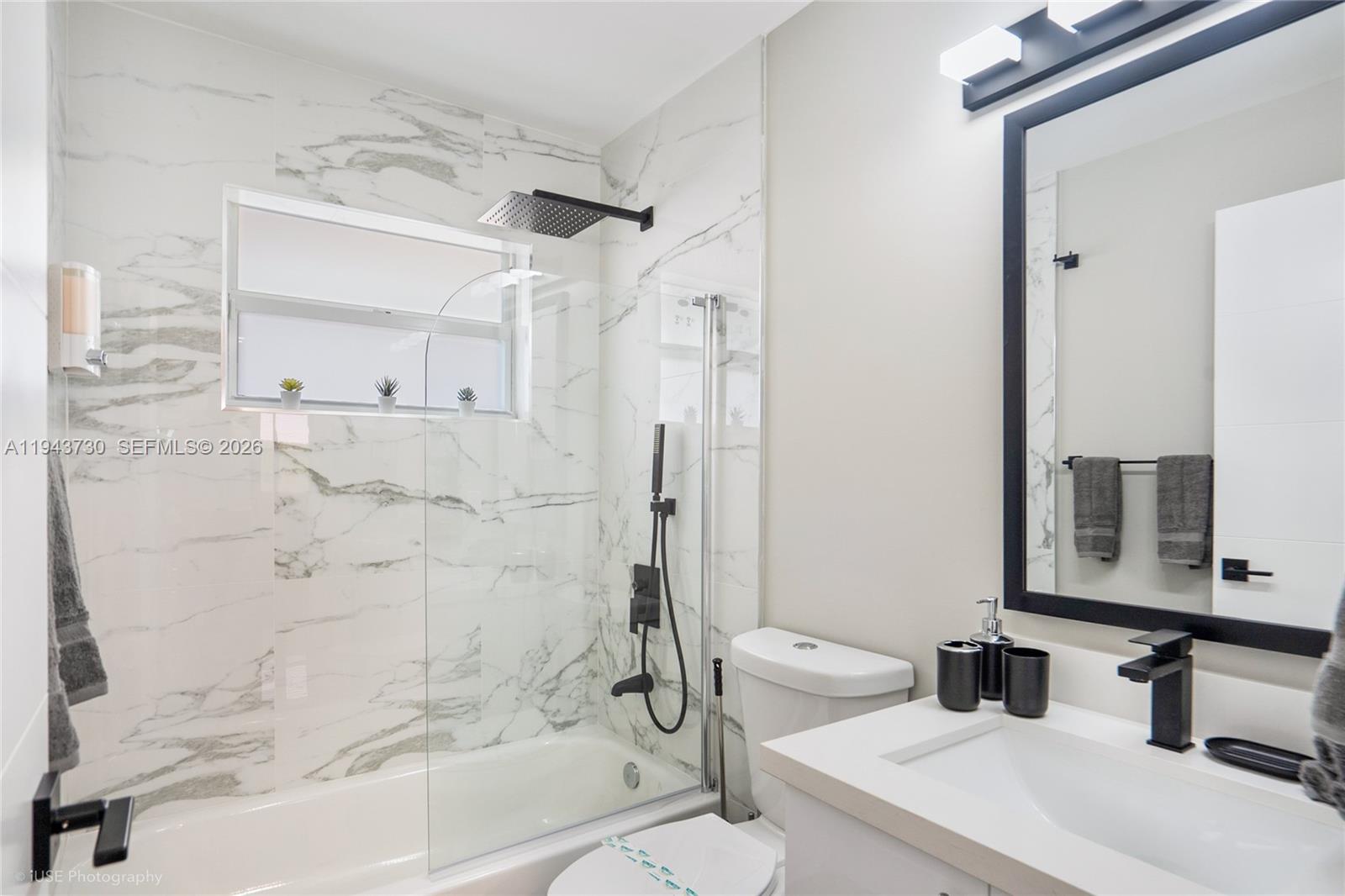 1035 Northwest 48th Street Miami, FL 33127 - Photo 9 of 29 a bathroom with a sink toilet and shower