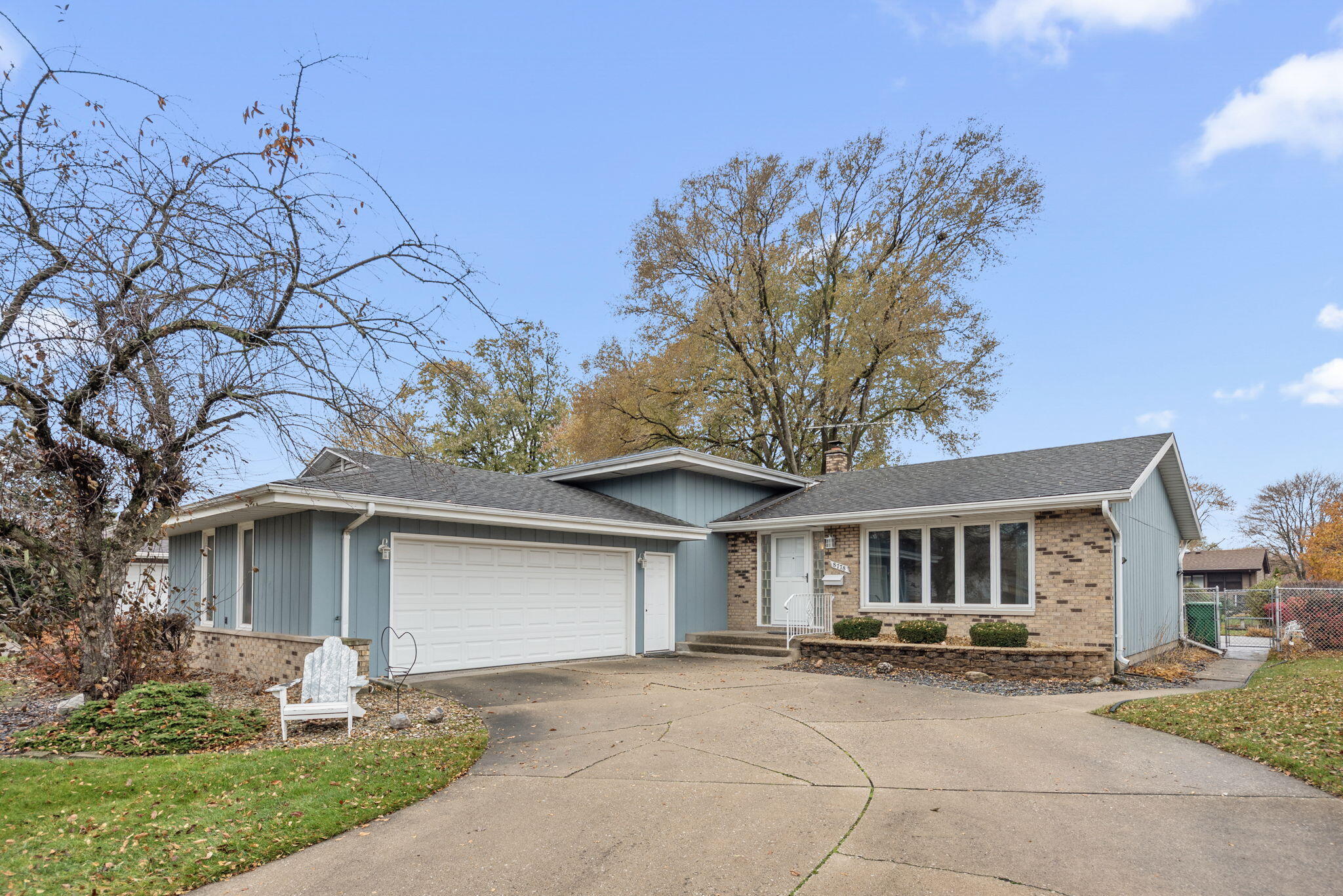 front view of a house with a yard and trees