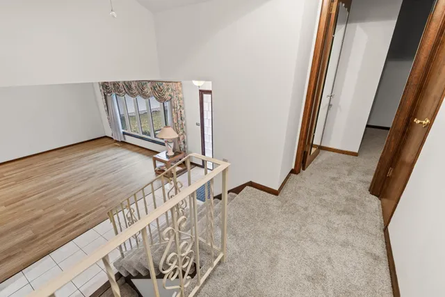 a view of a room with wooden floor