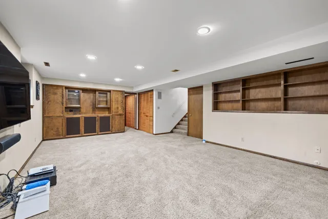 a view of an empty room with a fireplace and a cabinet