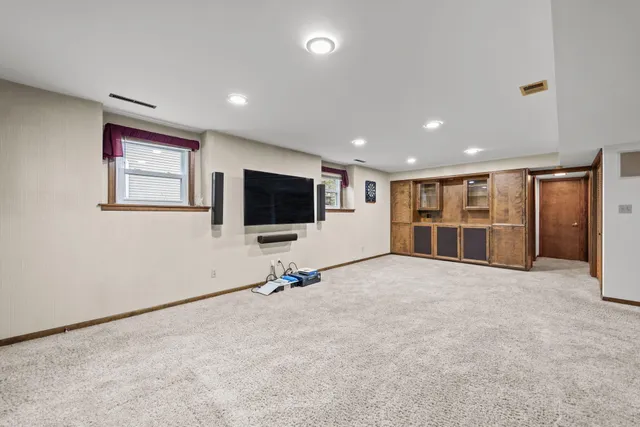 a view of a livingroom with furniture and a flat screen tv