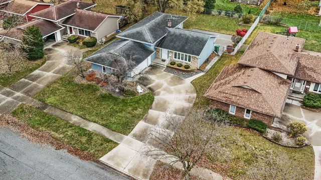 an aerial view of a house with a yard and garden