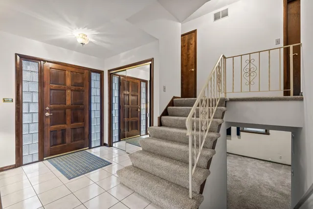 a living room with furniture and large windows