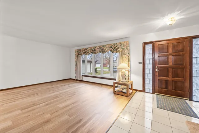 a view of a room with wooden floor and floor to ceiling window