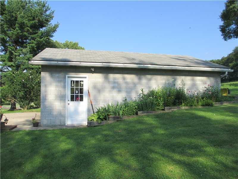 484 Flatwoods Road Vanderbilt, PA 15486 - Photo 19 of 20 Parking Lot/Garage. Man door into garage with a perennial garden on the side!