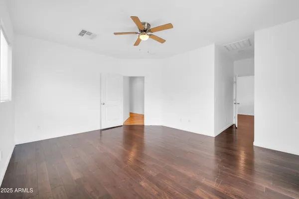 a view of a room with a window and a ceiling fan