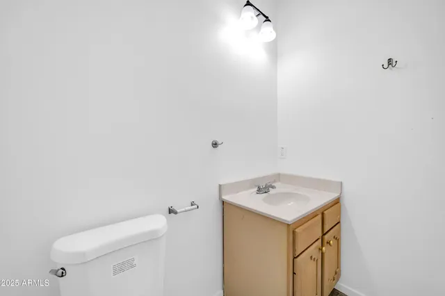 a bathroom with a toilet a sink a mirror and a bathtub