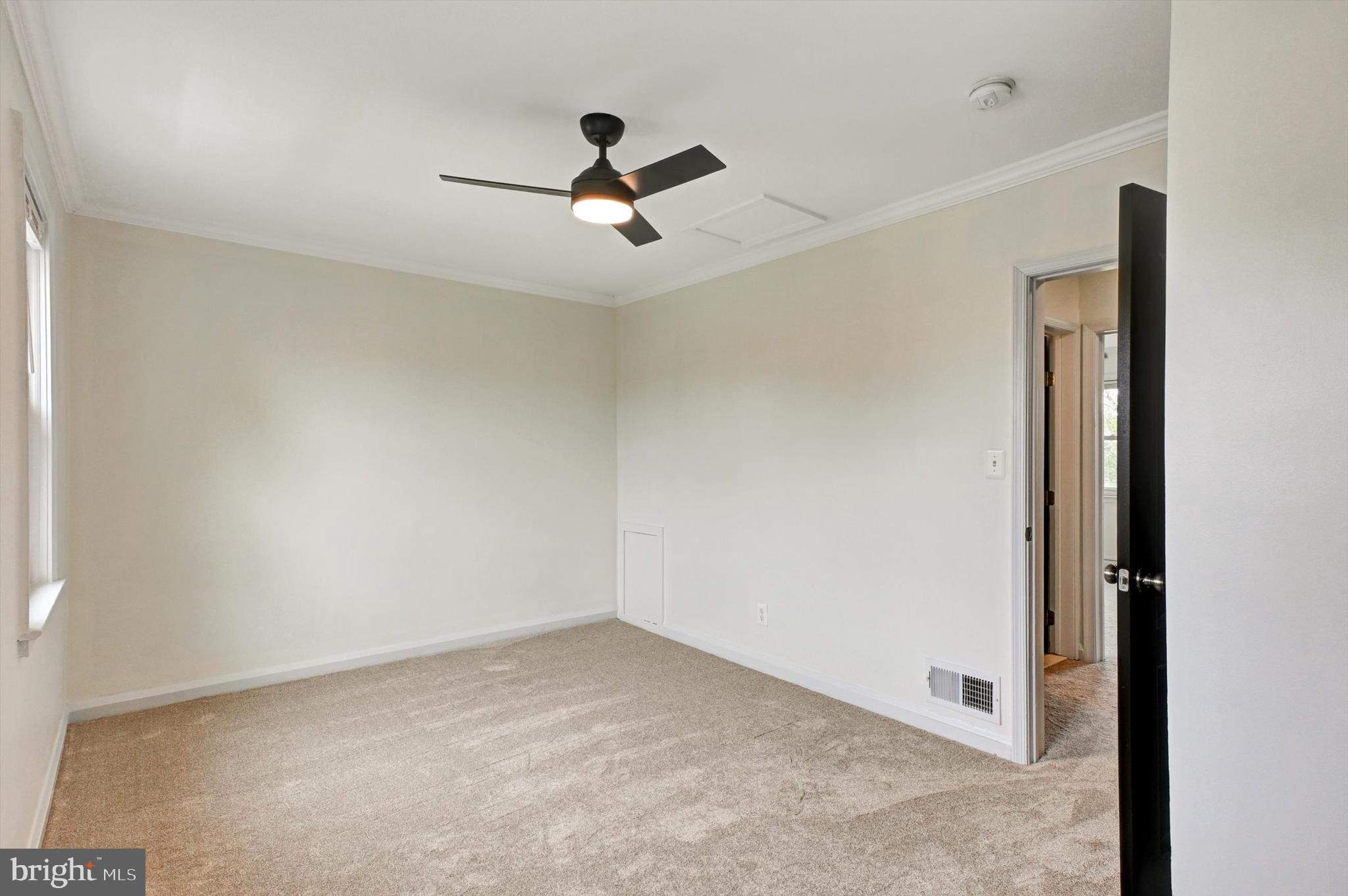 3521 Dunhaven Road Baltimore, MD 21222 - Photo 13 of 35 an empty room with a ceiling fan and a window