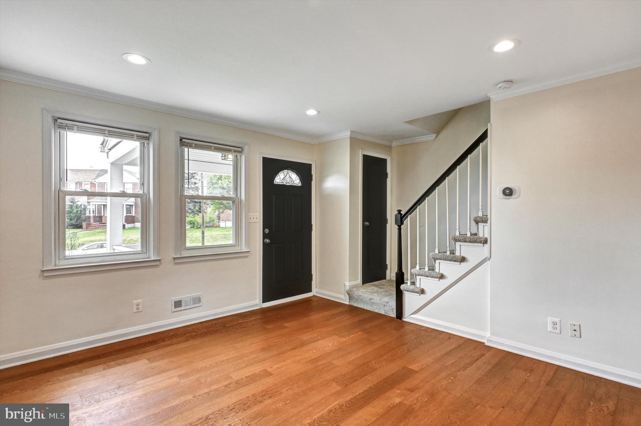 3521 Dunhaven Road Baltimore, MD 21222 - Photo 2 of 35 a view of an empty room with wooden floor and stairs