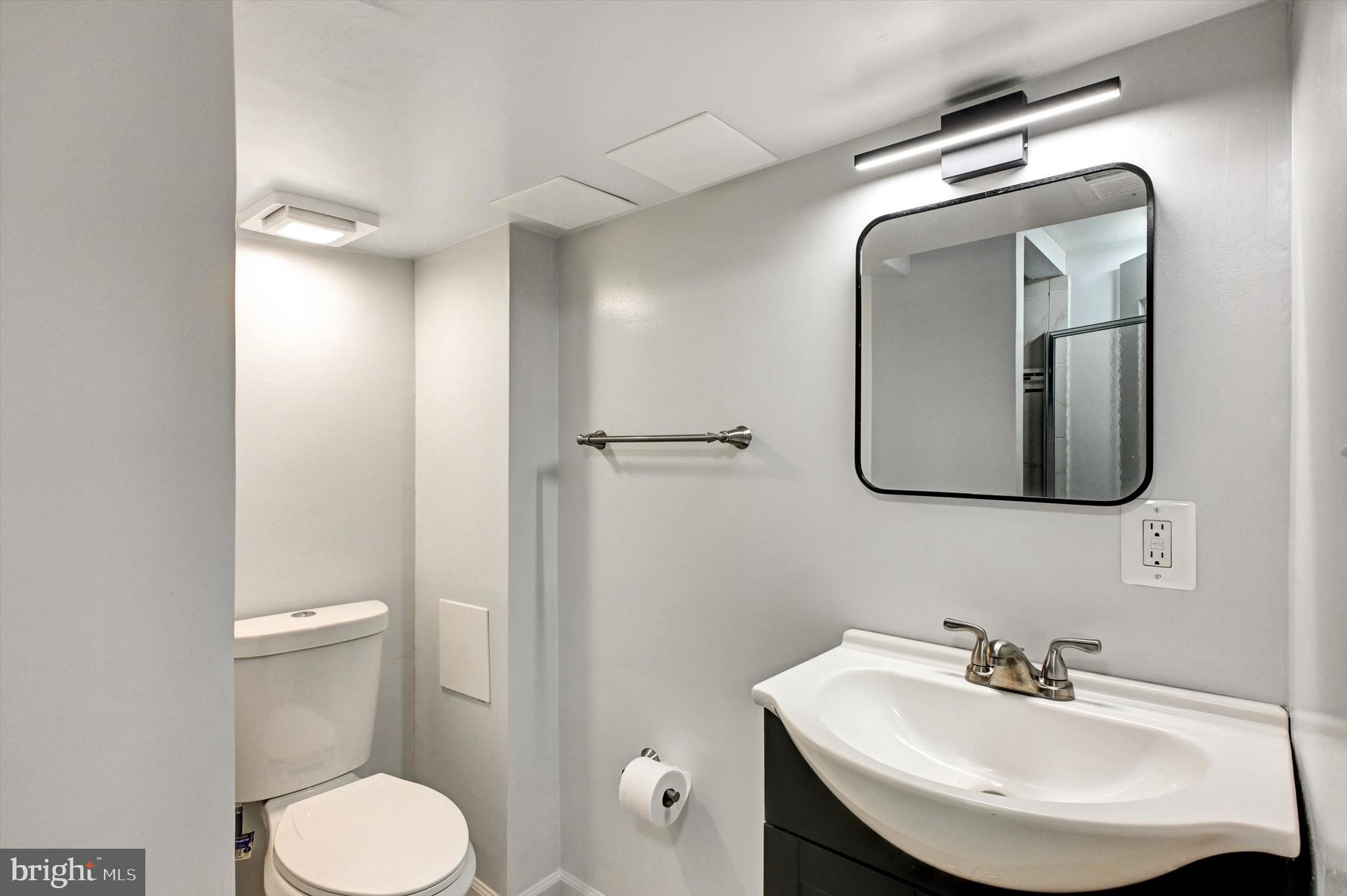 3521 Dunhaven Road Baltimore, MD 21222 - Photo 23 of 35 a bathroom with a toilet sink and mirror