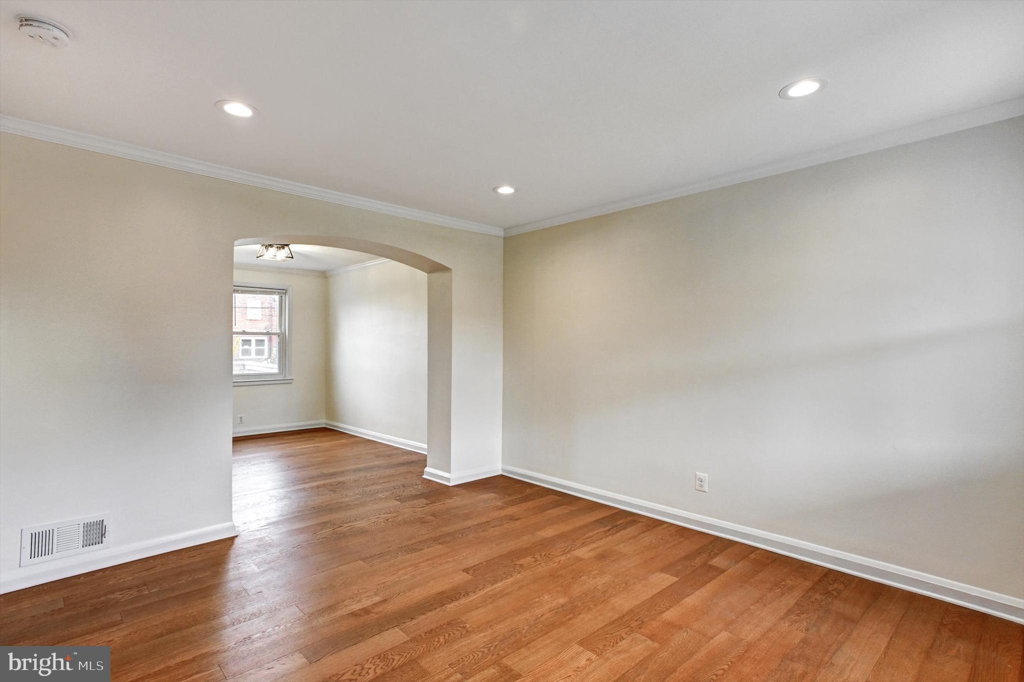 3521 Dunhaven Road Baltimore, MD 21222 - Photo 4 of 35 an empty room with wooden floor and windows