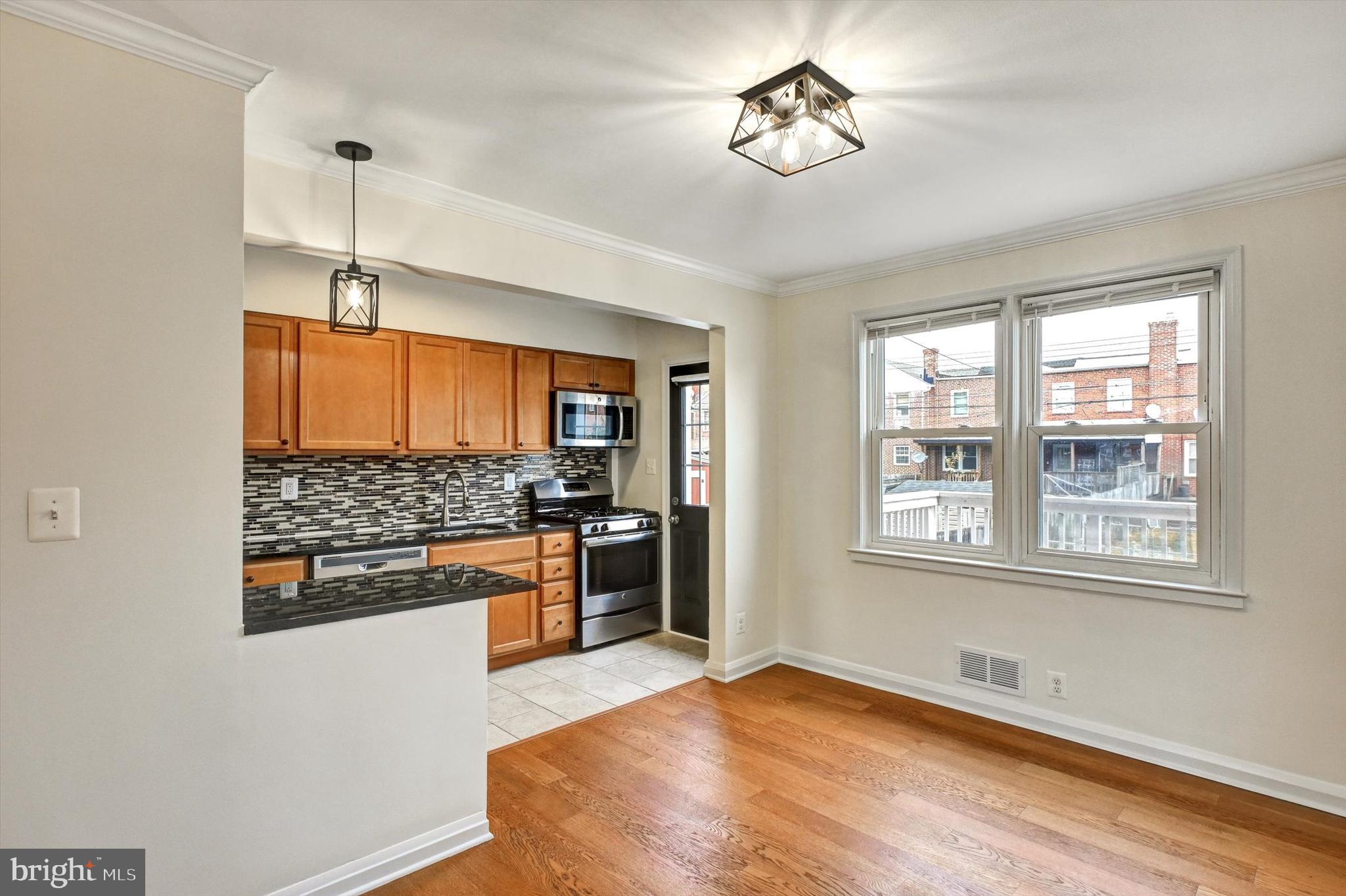 3521 Dunhaven Road Baltimore, MD 21222 - Photo 5 of 35 a view of a kitchen with a stove cabinets and wooden floor