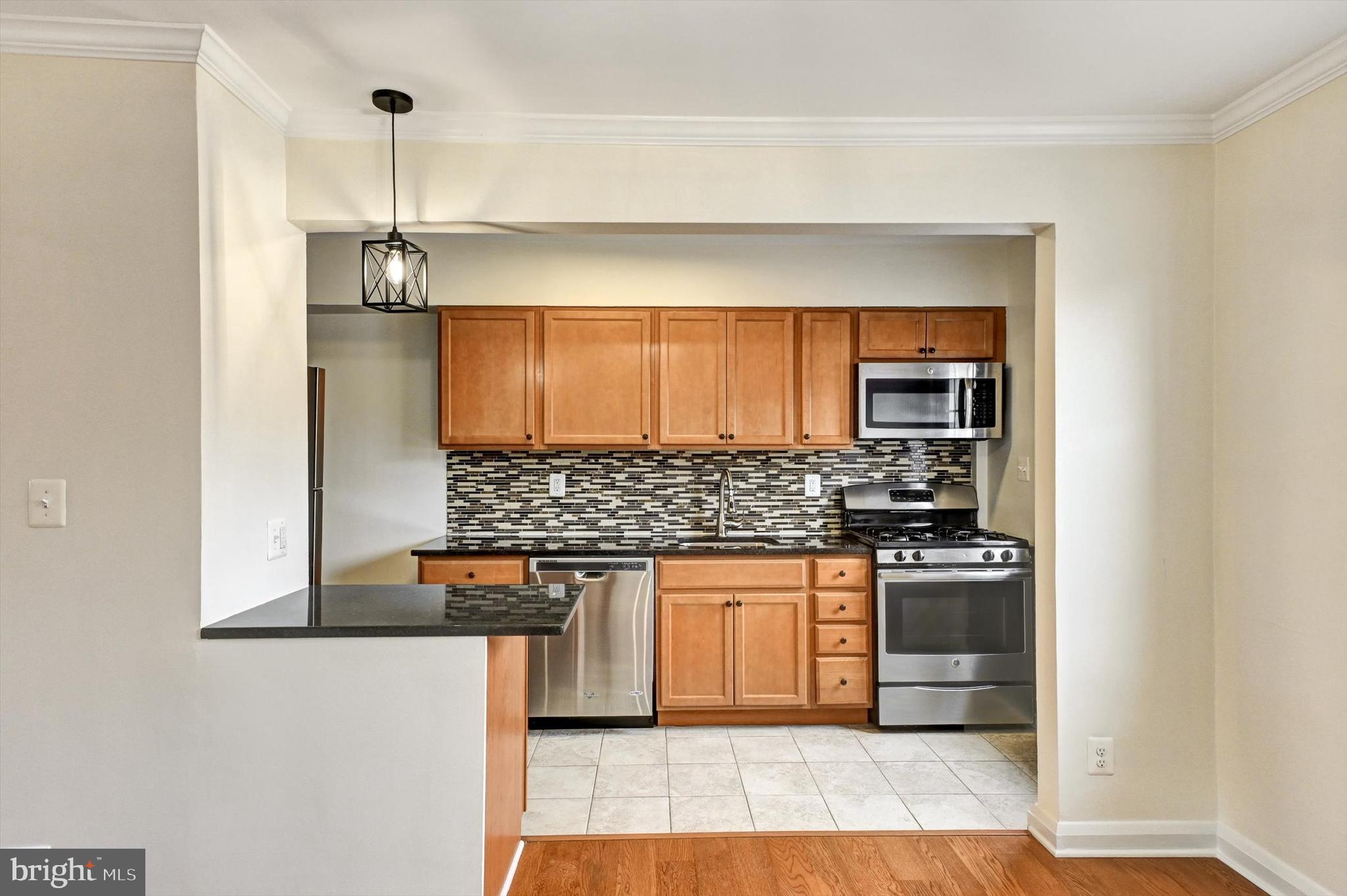 3521 Dunhaven Road Baltimore, MD 21222 - Photo 6 of 35 a kitchen with stainless steel appliances granite countertop a stove and a refrigerator