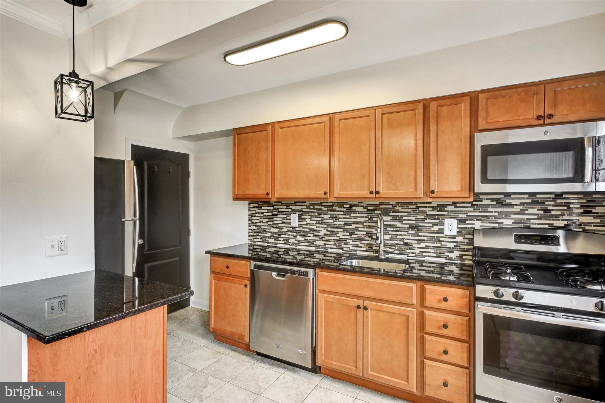 3521 Dunhaven Road Baltimore, MD 21222 - Photo 8 of 35 a kitchen with stainless steel appliances granite countertop a stove a sink and a microwave