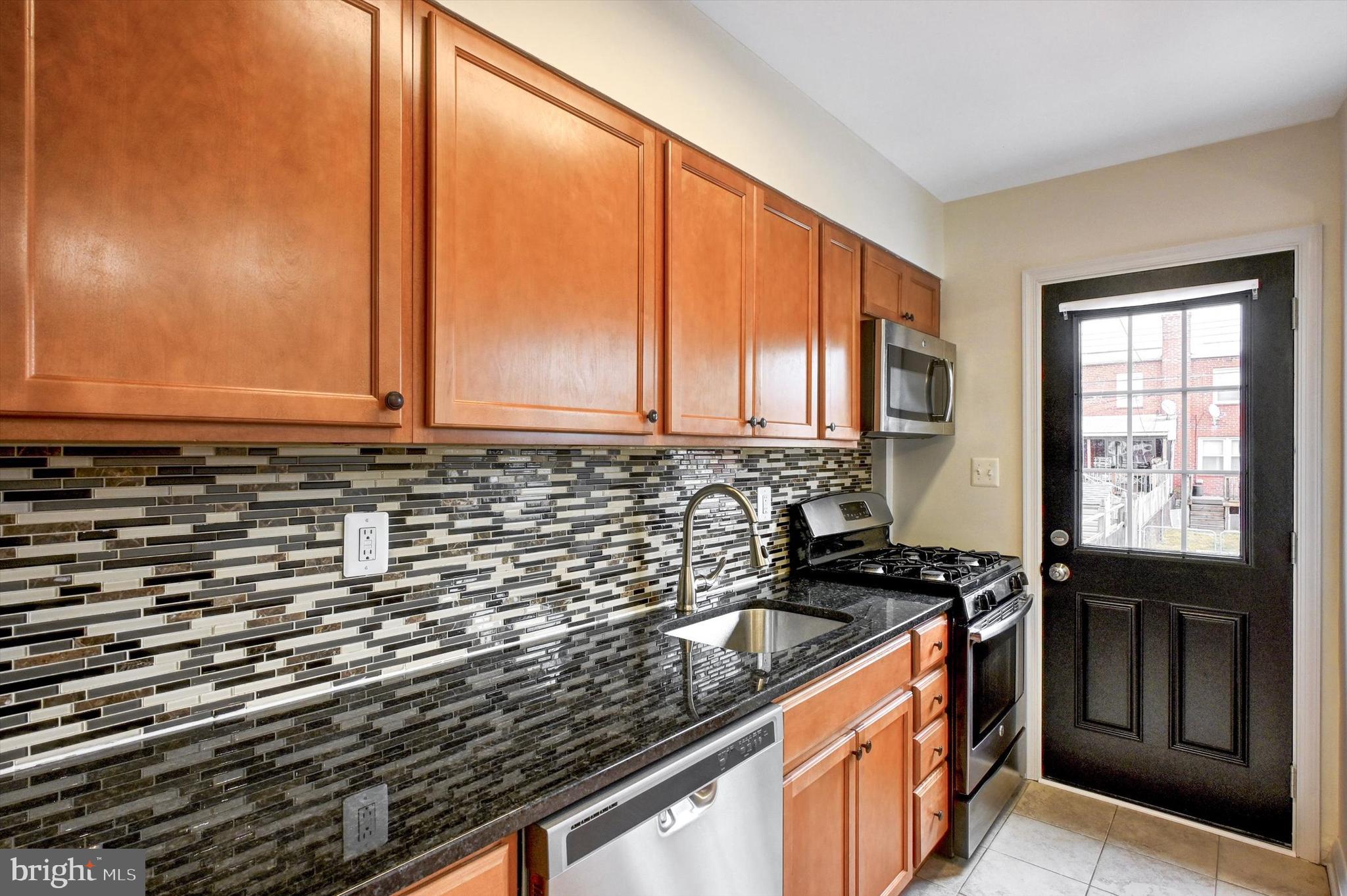 3521 Dunhaven Road Baltimore, MD 21222 - Photo 9 of 35 a kitchen with granite countertop a sink and a stove