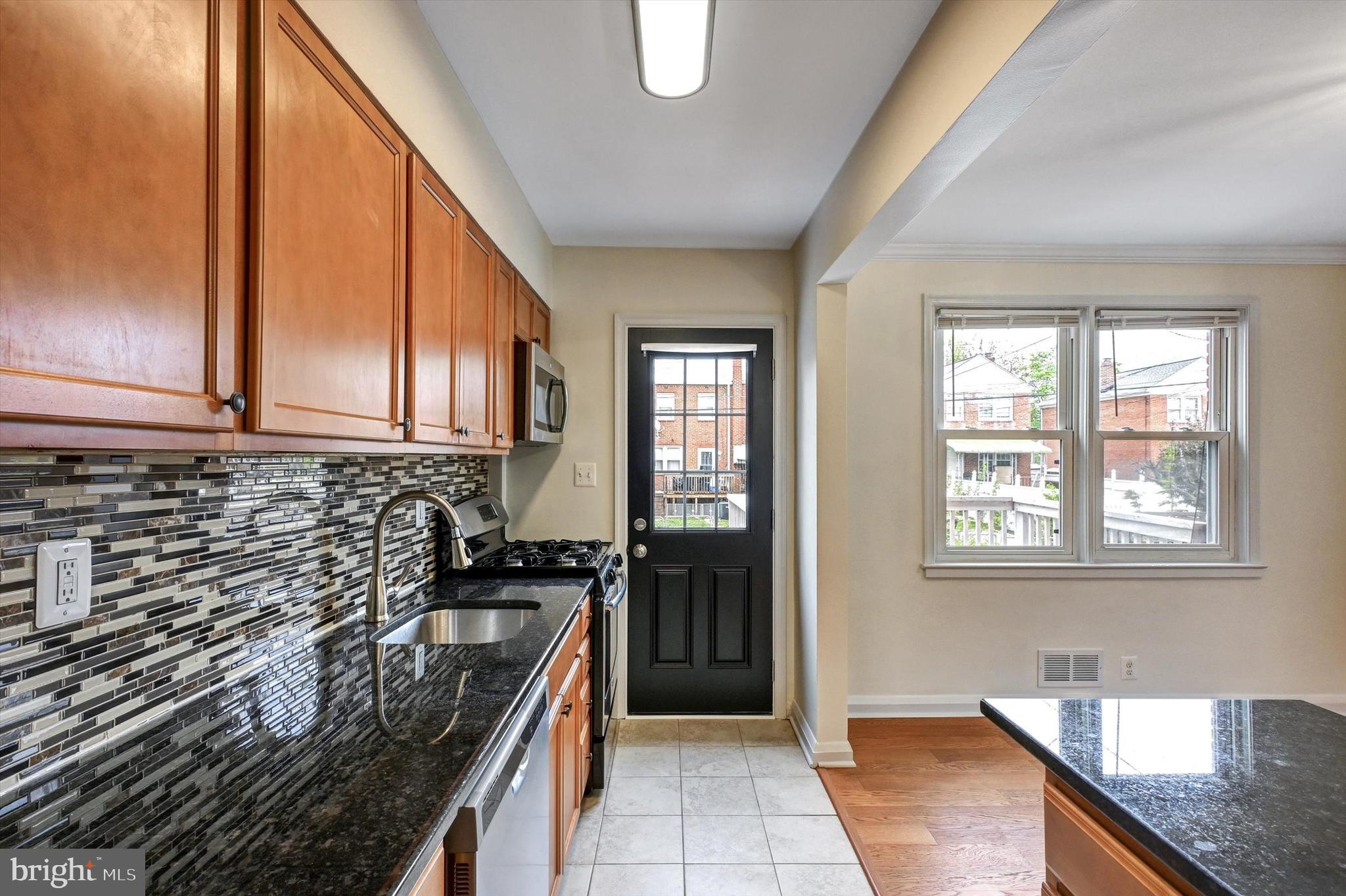 3521 Dunhaven Road Baltimore, MD 21222 - Photo 10 of 35 a kitchen with a sink stove and cabinets