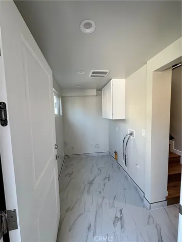 a view of a room with a sink and cabinets