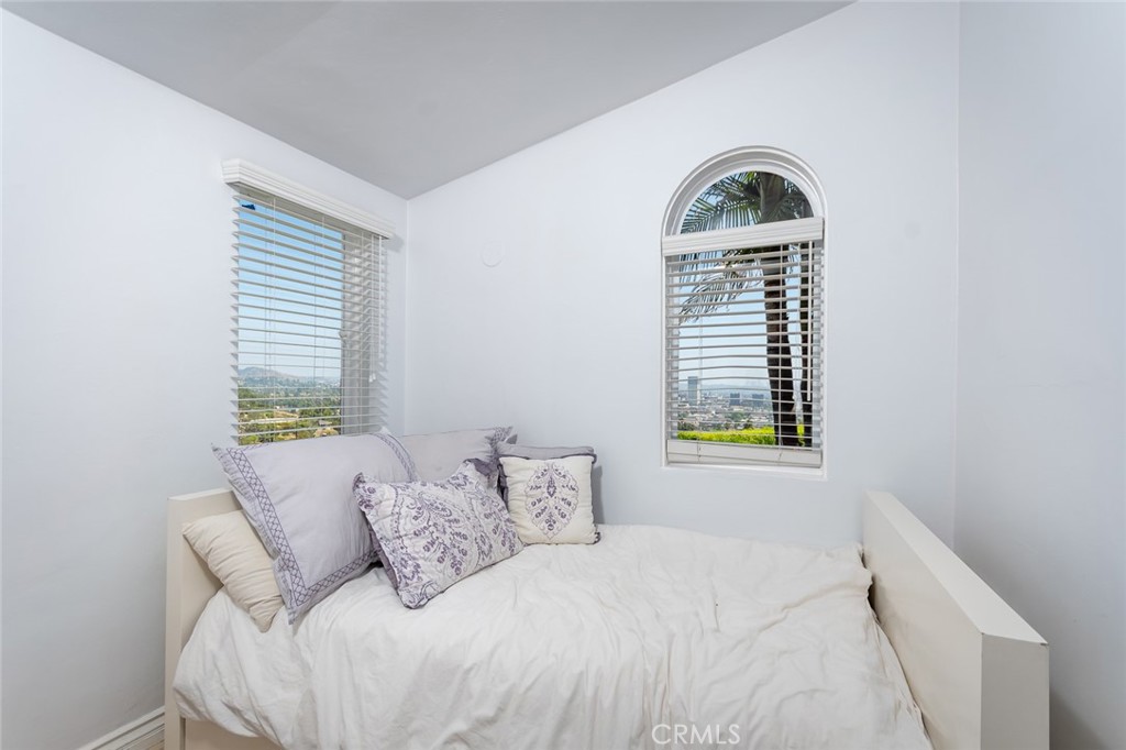 330 Kempton Road Glendale, CA 91202 - Photo 60 of 75 a bedroom with a bed a window and flowerpot