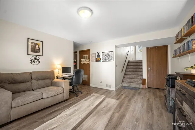 a living room with furniture and a wooden floor