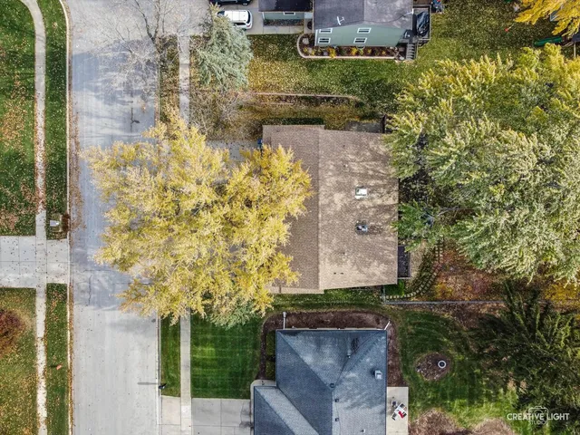 an aerial view of a house with a yard