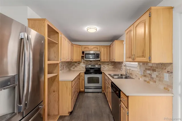a kitchen with a sink stove and refrigerator