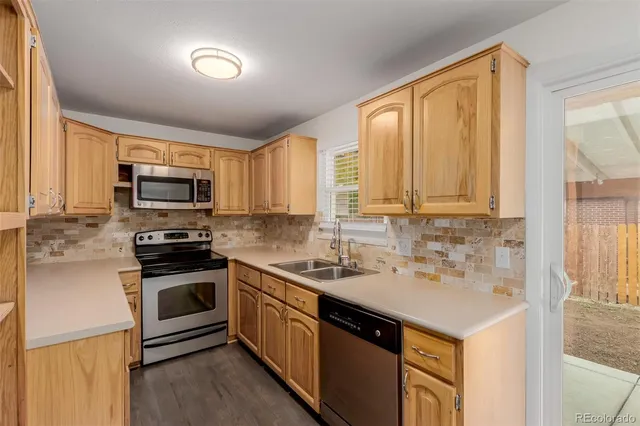 a kitchen with a sink stove and microwave