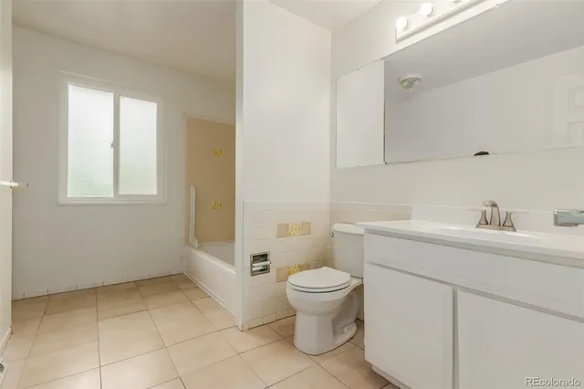 a bathroom with a sink toilet and window