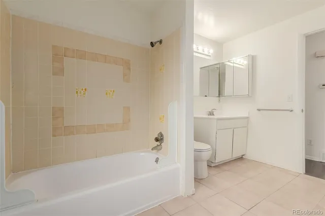 a spacious bathroom with a bathtub shower sink mirror and toilet
