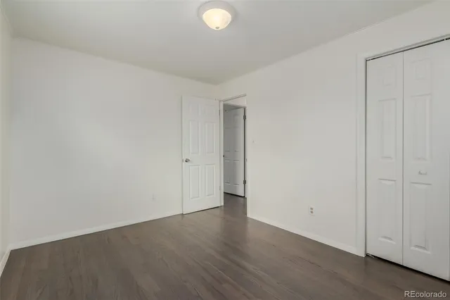a view of an empty room and wooden floor