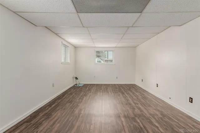 a view of a room with wooden floors and white walls