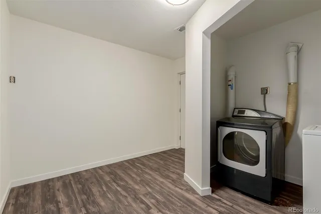 a utility room with washing machine and a view of bedroom