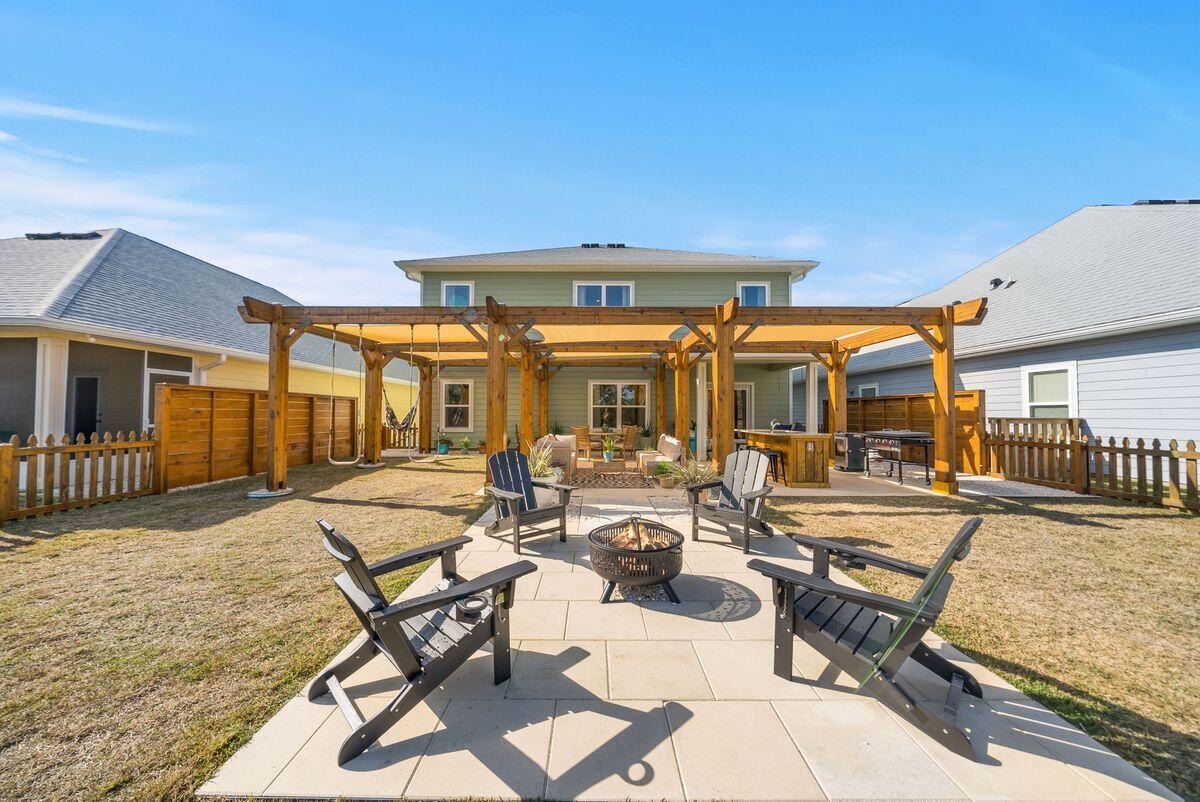 774 Backwater Road Port St. Joe, FL 32456 - Photo 2 of 65 a view of a patio with dining table and chairs with wooden floor