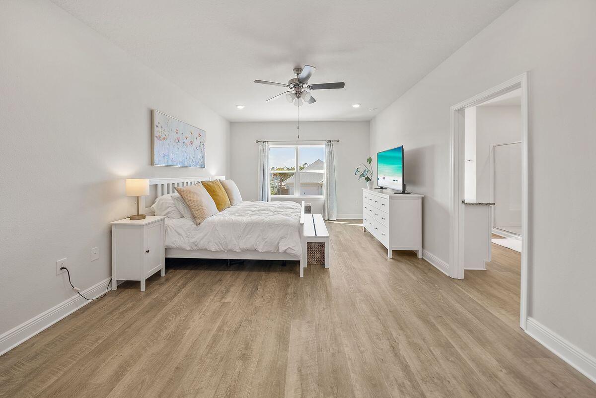 774 Backwater Road Port St. Joe, FL 32456 - Photo 21 of 65 a bedroom with a bed and a chandelier